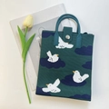 Close-up of green knitted tote bag with bird pattern and cylindrical handles on white background - Green Cloud Bird