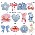 Detail view of 12-piece blue and pink cartoon embroidery patches with floral and cute designs - 12Pcs Fresh Patch Set