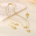Detail of gold layered snake chain necklace, leaf ring and earrings set with cat eye stones - One Size Ring / Milky White (KS220681-LX)
