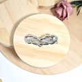 Polished silver alloy heart-shaped knot hair clip on a wooden base with a pink rose - Silver Heart Twist