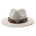 Detail of western straw hat featuring brown leather band and silver bull head emblem - Gray