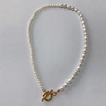Detail shot of white pearls and golden OT toggle clasp on a bohemian necklace - Large And Small Round Pearl
