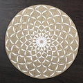 Round jute placemat featuring a white geometric pattern on a dark wood table - 38cm / White Dandelion