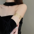 Golden leaf cutout arm cuff bracelet worn on arm over black velvet fabric detail - Gold Hollow Leaf Style (8#)