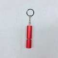 Detail of red cylindrical travel perfume atomizer with portable silver keychain and chain - Red