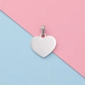 Polished heart-shaped stainless steel pendant for DIY jewelry on pink and blue background - Steel
