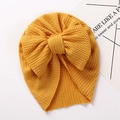 Detailed view of yellow waffle knit baby turban hat with a large bow decoration - Ginger Yellow