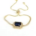 Detail of adjustable gold tennis bracelet with halo-set navy blue square zircon stone - Gold/Dark Blue