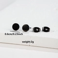 Macro view of 6mm black stainless steel stud earrings with butterfly backs on marble - 006 Black Round