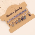 Detail of bohemian layered bracelets with blue beads and raw natural stone charms - Lapis Lazuli