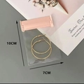 Pink EVA jewelry storage bag 10x7cm containing golden twisted hoop earrings - 7x10cm/pc / Pink