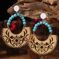 Western style turquoise wood earrings with tribal hollow patterns on tree bark background - Natural Wood Hollow + Blue Textured Beads