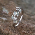 Elegant olive branch silver ring with oval opal stones and sparkling diamond accents - Platinum White Opal
