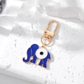 Detail of blue evil eye elephant keychain with gold plating on a stone surface - 6# Dark Blue Elephant