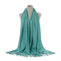 Detailed view of turquoise cashmere feel scarf texture and fringe on display mannequin - Lake Blue