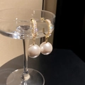Macro shot of large white pearl earrings with zircon inlay on a clear glass rim - 14# Champagne Pearl