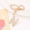 Detailed close-up of golden letter N keychain with sparkling crystals and lobster clasp - Letter N