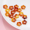 Translucent amber acrylic flower charms for DIY jewelry making displayed on a white plate - 14mm / 6# Transparent Dyeing (kp6522)