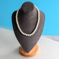 Elegant white pearl necklace on grey velvet jewelry stand with natural wood base - Large Dark Grey Velvet