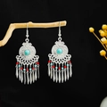 Bohemian silver earrings featuring turquoise beads and metallic tassels on a dark background - Colorful