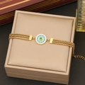 Dettaglio del bracciale occhio greco dorato con intarsio turchese su portagioie - 2# Braccialetto / Oro