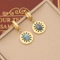 Detailed close-up of golden sunburst earrings featuring oval blue textured stones on a box - Blue Oval Stone Texture Style(4#)