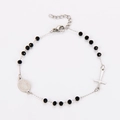 Detalle de cuentas talladas negras y crucifijo plateado en pulsera de acero inoxidable - Color Acero