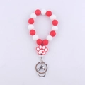 Detail of red and white silicone beaded wristlet with heart patterned dog paw pendant - Red