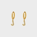 Macro shot of gold plated J letter pendant earrings with pavé white zircon stones - Letter J