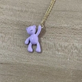Minimalist golden chain necklace featuring a purple enamel bear pendant on a grey surface - Large Bear / Purple