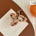 Detail of butterfly claw clip featuring vintage tortoiseshell pattern and acetate texture - Patterned Tortoise