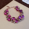 Macro detail of rose gold vintage bracelet with purple beads and sparkling rhinestones - Rose Gold Purple Flower Leaf Bracelet