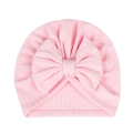 Detail of baby pink ribbed knit hat featuring a large decorative bow for newborns - Pink