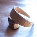 Detailed view of brown raffia woven headband placed on a scented candle jar background - Brown Solid Wide Edge