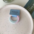 Spiral telephone cord hair ties in blue and pink tones on a decorative plate - Two-tone Blue Pink Single Thick
