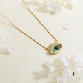 Close-up of gold plated evil eye pendant with green stone and white zircon stones - Green Main Stone - Gold Box Chain