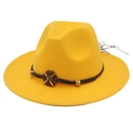 Detailed close-up of yellow felt fedora hat with brown woven band and gold flower charm - M (56-58cm) / Yellow