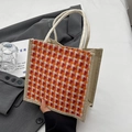 Handheld jute tote bag featuring orange and red houndstooth woven pattern with rope handles - Zipper Style / Red