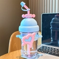 Pink and blue cartoon water bottle with heart decoration and straw on a wooden table - Heart Blue Pink