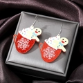 Macro shot of gingerbread man and red mug acrylic earrings in a luxury jewelry gift box - Red Snowflake Cup (Silver Hook)
