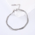 Multi-layered stainless steel silver bracelet for women on white marble background - Silver Bracelet