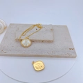 Macro detail of gold plated necklace with a square zircon pendant on a beige stone surface - White Number 8C Square