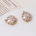 Detailed close-up of a gold-plated flower clasp with micro-set zircons for jewelry making - 06# White Double-Row Clasp