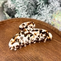 Detailed view of large black and white marble acetate hair claw clip on a wooden tray - Coffee Jelly