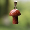 Sparkling red goldstone mushroom pendant with metal clasp in natural outdoor light - Synthetic Goldstone