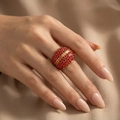 Macro detail of gold plated ring with micro-pave red crystals on elegant fabric background - US 6 / Red