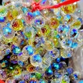 Macro shot of 8mm multifaceted strawberry crystal glass beads with iridescent finish coating - Starry Purple