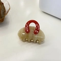 Detail of small handbag-shaped hair claw clip with red handle and printed numbers - Red Khaki Handbag Small