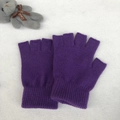 Close-up of purple knitted fingerless gloves with ribbed cuffs on a soft plush background - One Size / Purple