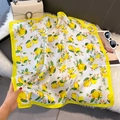 Detailed view of silk square scarf with vibrant lemon print and yellow border accent - 70*70cm / White Lemon